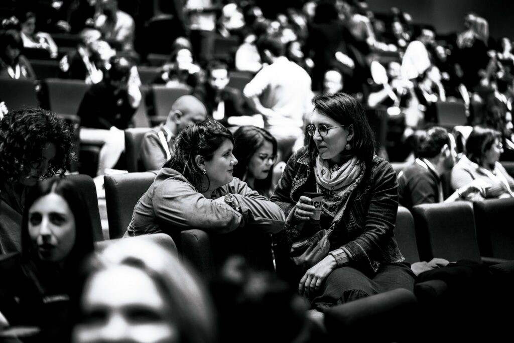 Des participantes échangent entre elles en attendant le début de la conférence